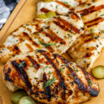 dill pickle marinated chicken breasts on a cutting board