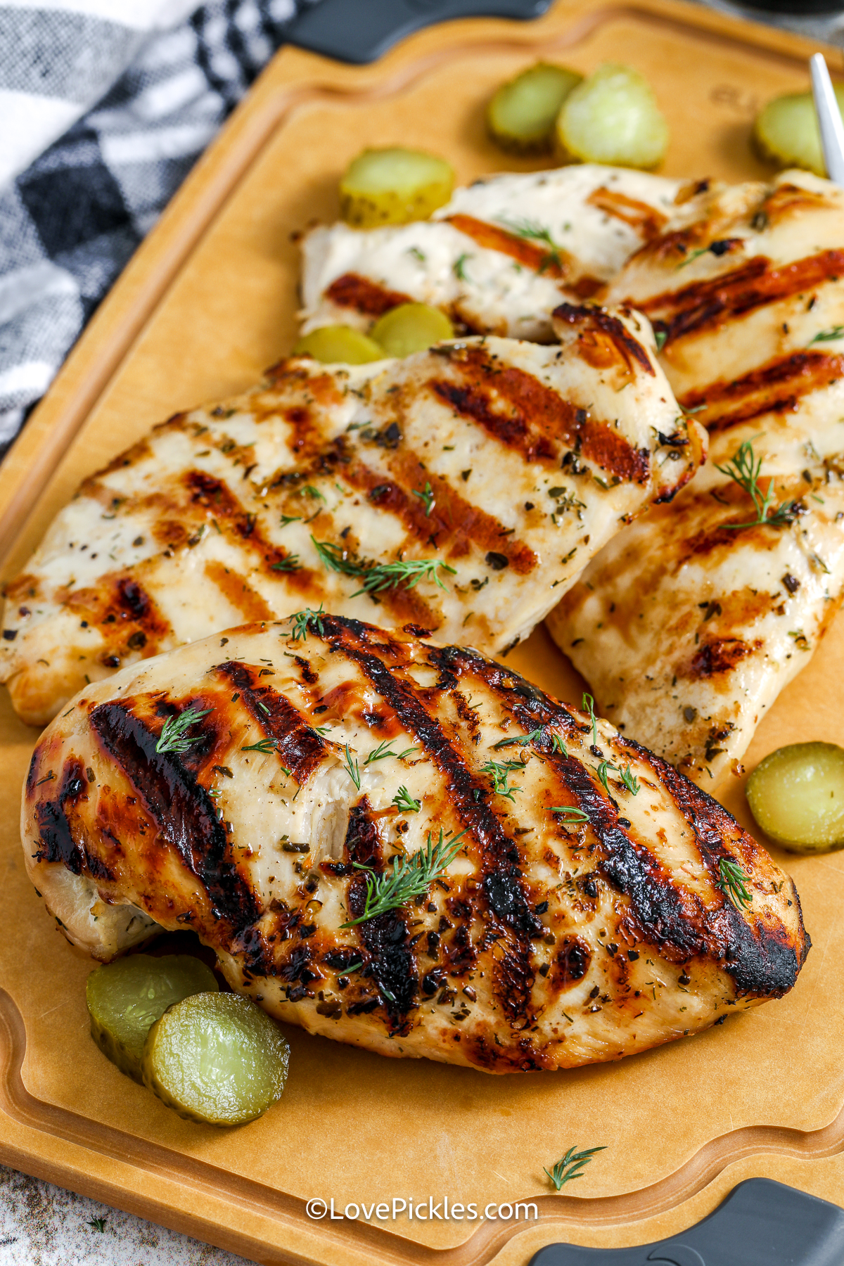 dill pickle marinated chicken breasts on a cutting board