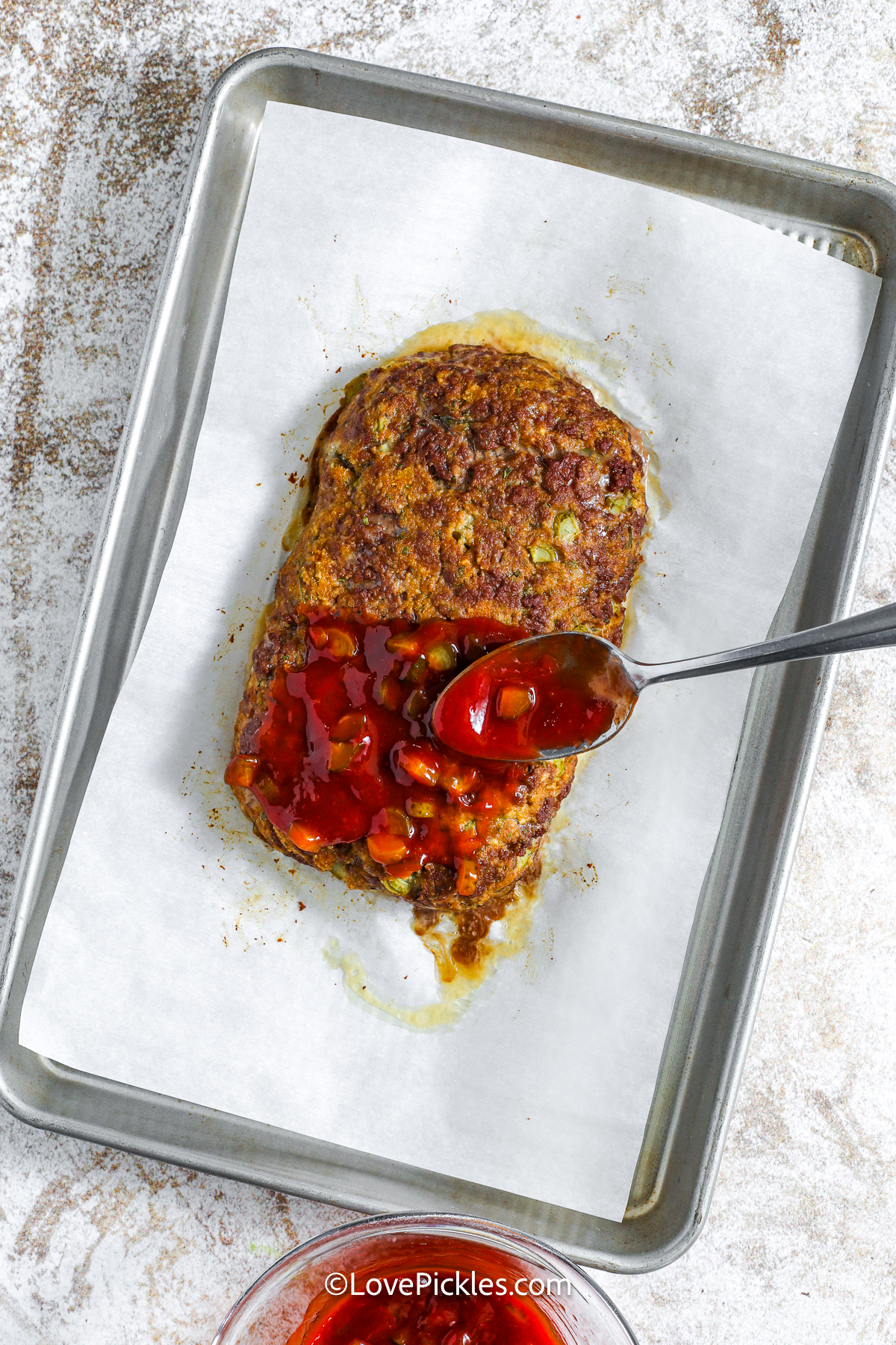 putting sauce on dill pickle meatloaf