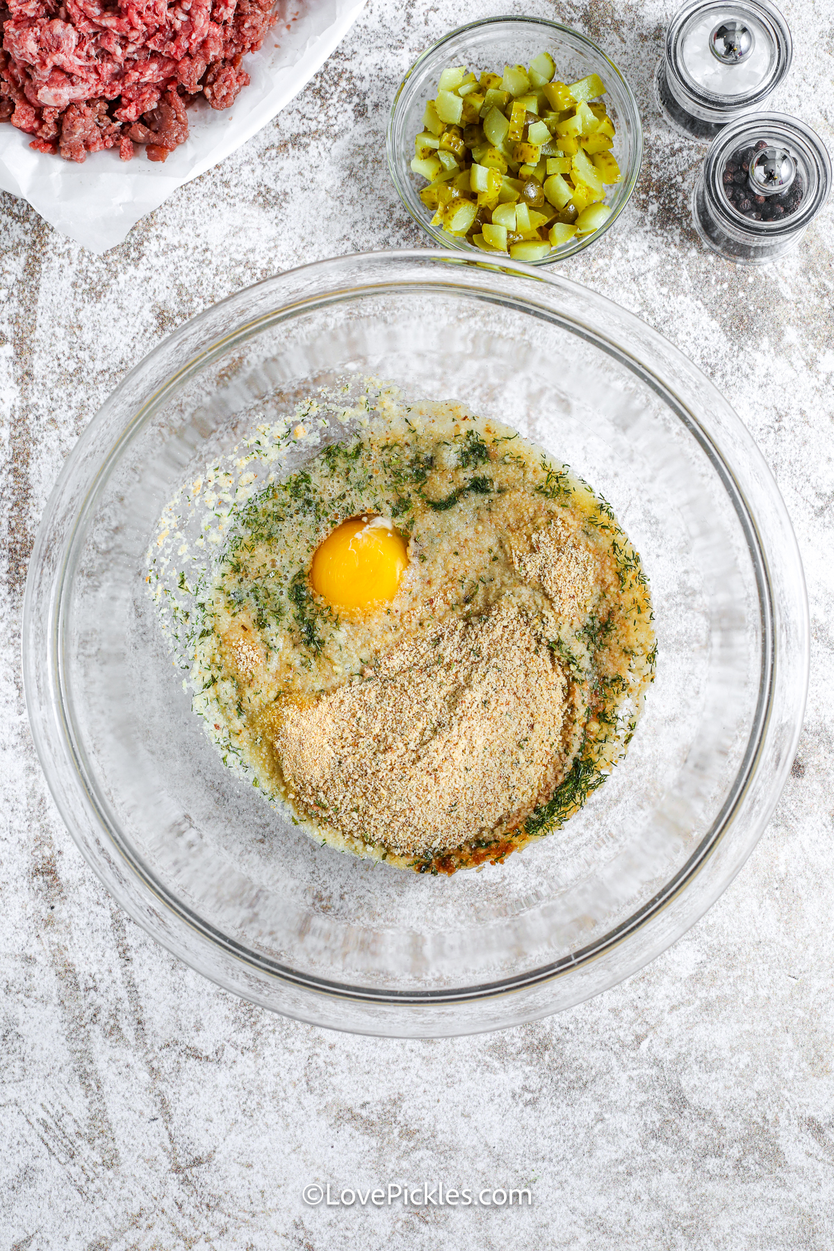 egg and seasoning in a bowl to make dill pickle meatloaf.