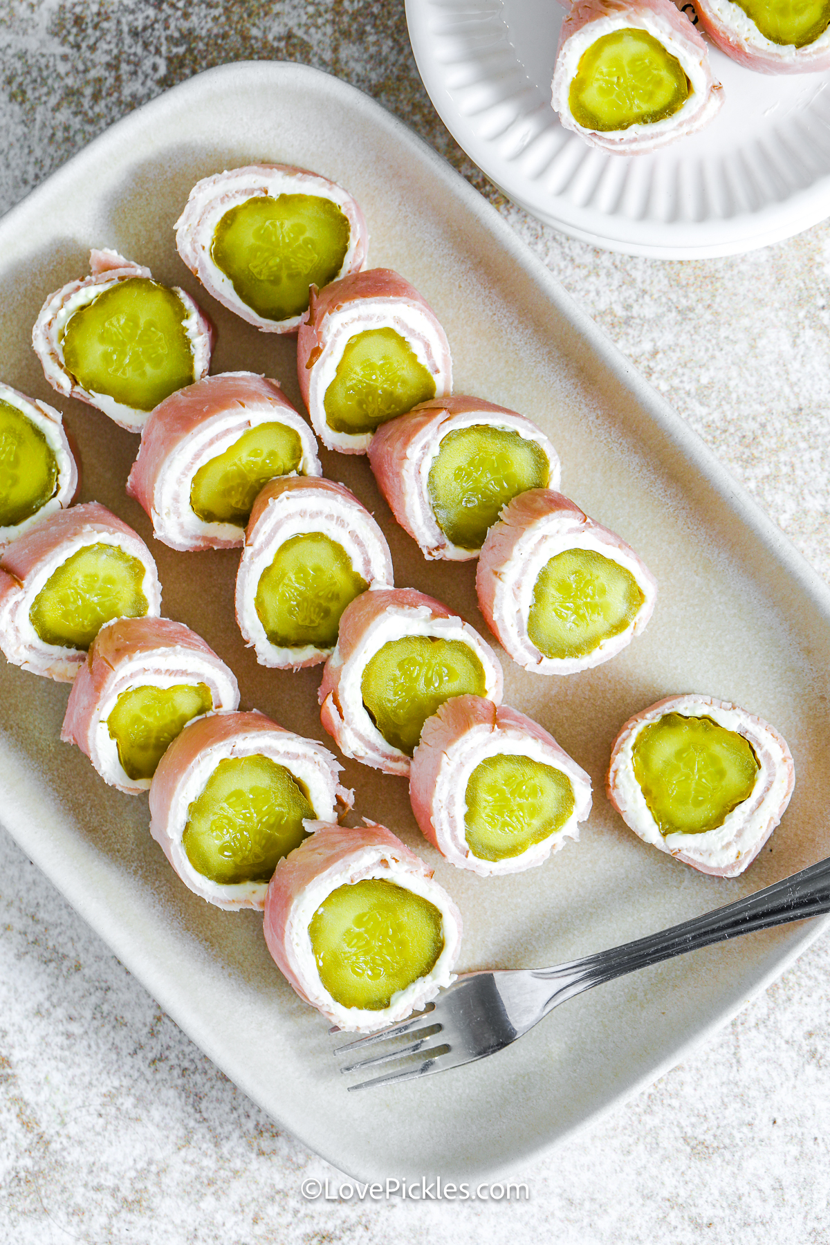 sliced dill pickle roll ups on a plate