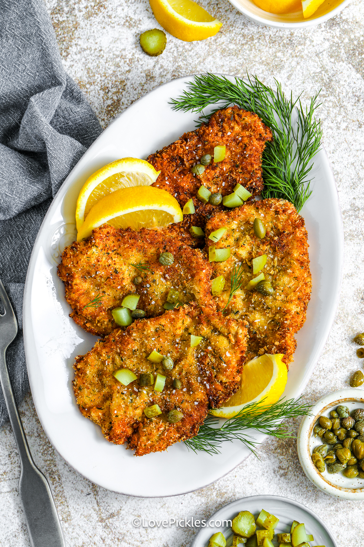 looking down on dill pickle schnitzel on a plate.