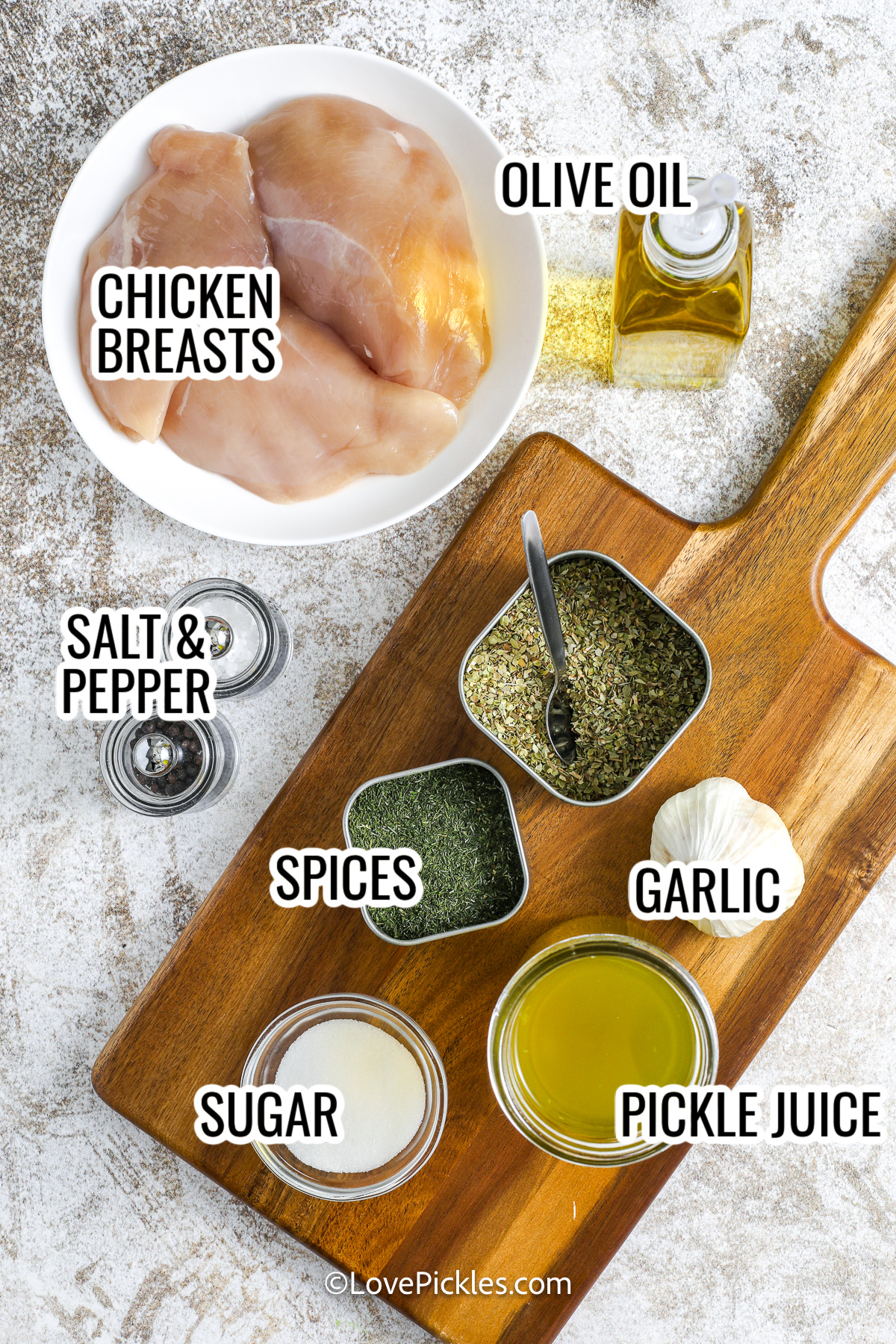 looking down on ingredients for dill pickle marinated chicken breast, including chicken breasts, pickle juice, garlic, spices, sugar, and olive oil