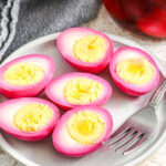 beet pickled eggs on a plate with a fork