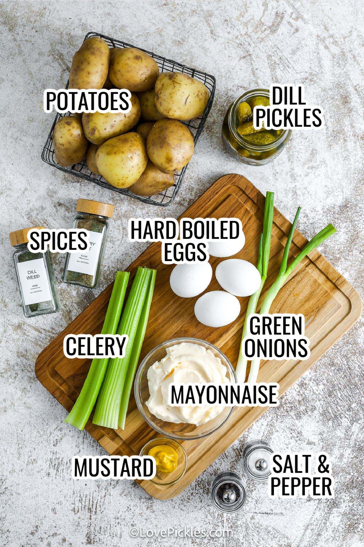 This recipe for dill pickle potato salad is the perfect mix of creamy, crunchy, and tangy goodness. Made with Yukon gold potatoes, chopped dill pickles, celery, and egg, it's loaded with texture and bold flavor. The simple dressing is a zesty combo of mayo, mustard, pickle juice, and dill. Chill it for a few hours and let the flavors shine—this is the best BBQ or picnic side dish! #lovepickles ingredients for dill pickle potato salad, including potatoes, dill pickles, spices, hard boiled eggs, green onions, celery, mustard, mayonnaise, and salt and pepper