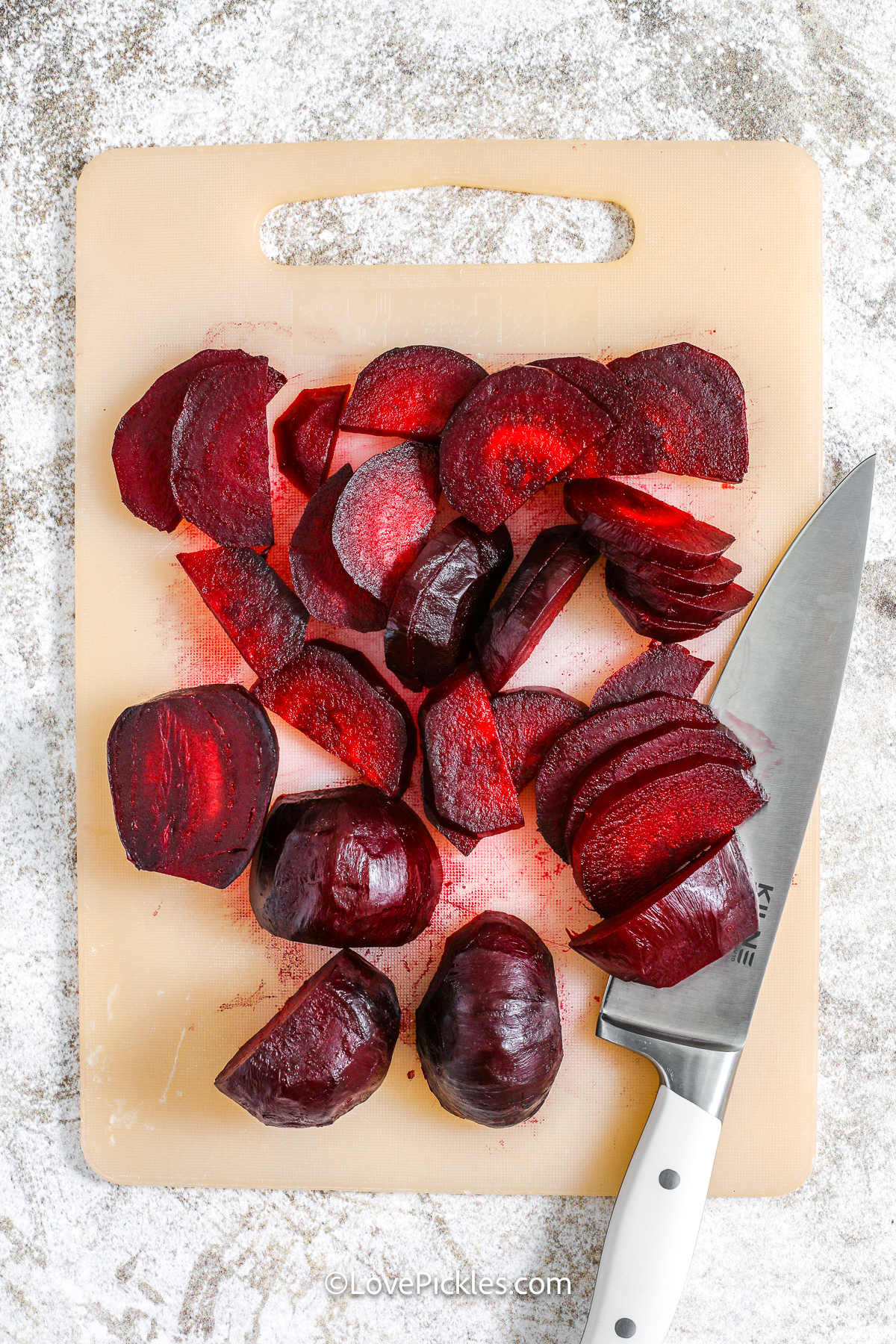 sliced beets on a cutting board to make quick pickled beets.