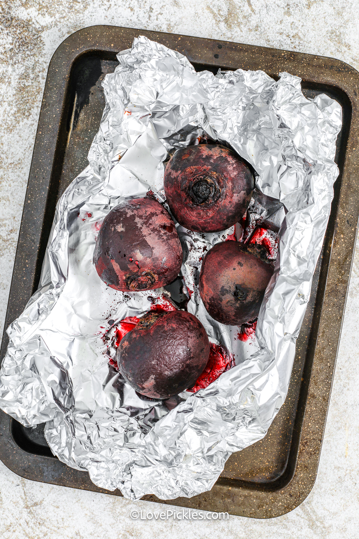 cooked beets on a pan to make quick pickled beets.