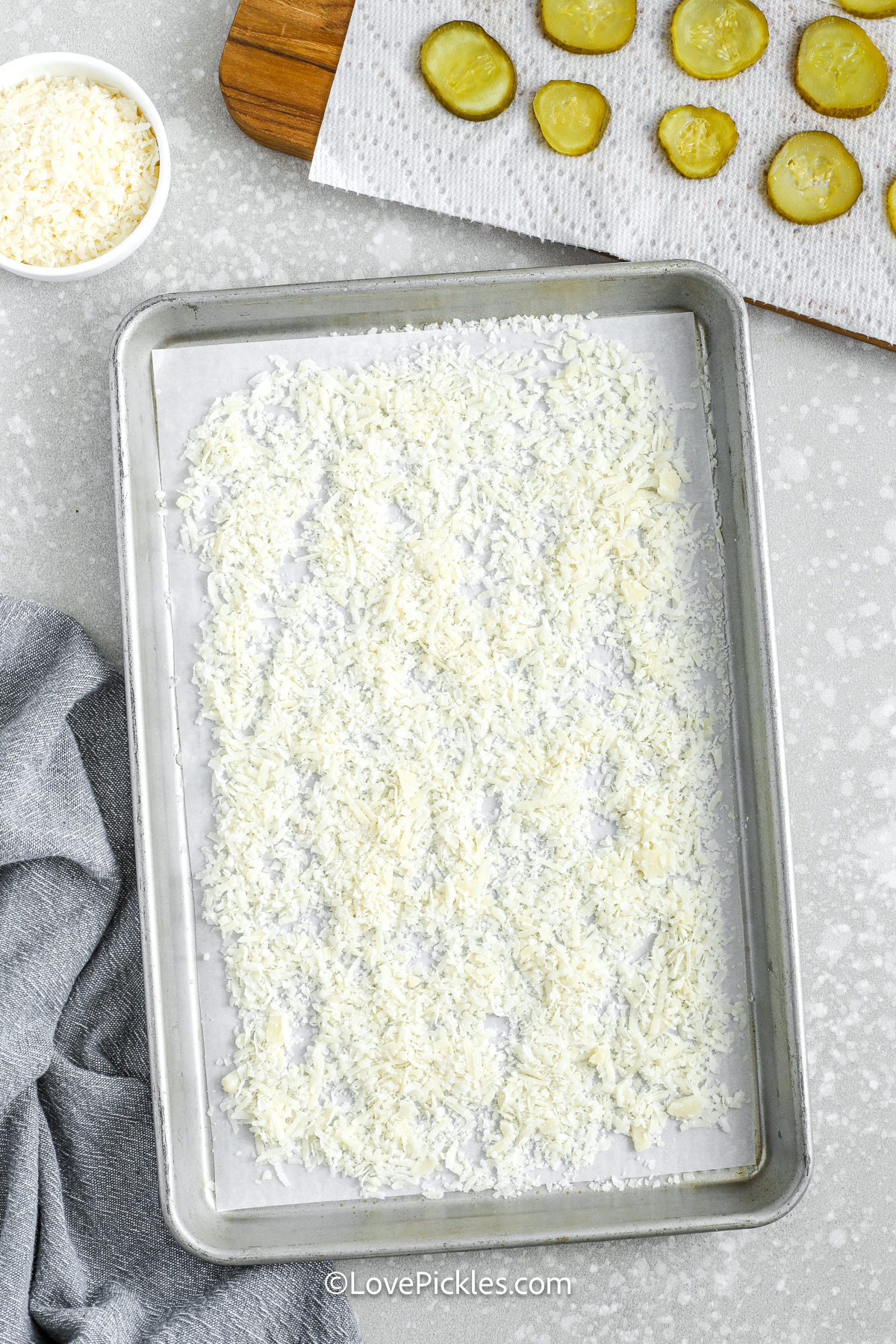 shredded cheese on a baking sheet to make cheese pickle chips