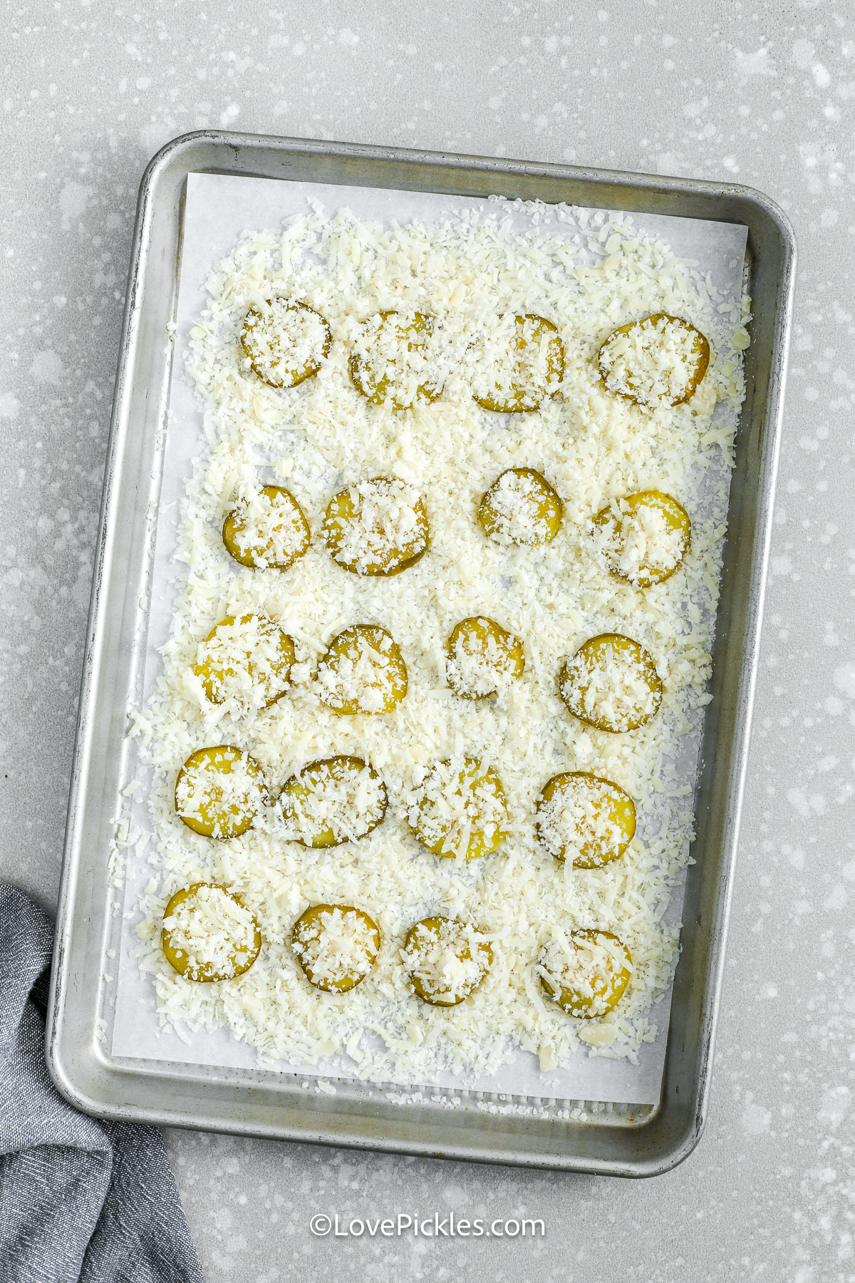 pickles and shredded cheese on a baking sheet to make cheese pickle chips