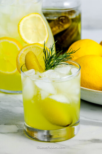 viral dill pickle lemonade garnished with dill