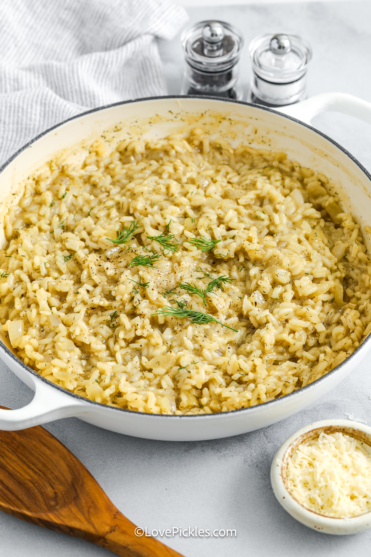 Dill risotto brings together creamy texture and sharp flavor in perfect balance. The arborio rice slowly absorbs tangy pickle juice and savory chicken broth, while onions, garlic, and white wine build deep flavor. Parmesan and butter stirred in at the end make it rich and satisfying. It’s a creative side dish or meatless main that turns simple ingredients into something bold and unexpected. #lovepickles dill risotto and dill in a pot