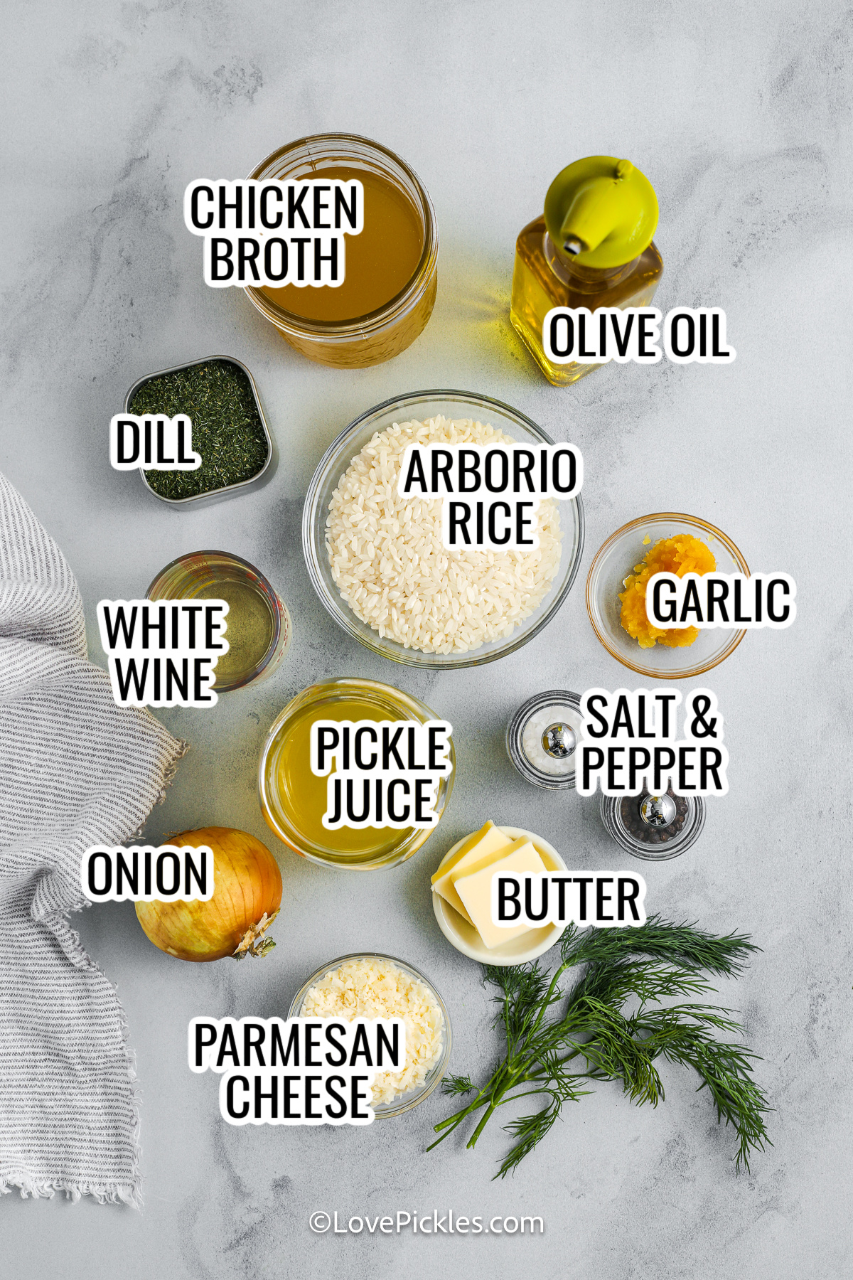 Dill risotto takes a classic creamy dish and gives it a bold, briny twist. Arborio rice is simmered slowly with a mix of warm chicken broth and dill pickle juice, then finished with butter, Parmesan cheese, and fresh dill. The result is a tangy, rich, and savory risotto that’s surprisingly comforting and packed with flavor. It’s perfect for adventurous eaters or anyone craving something different. #lovepickles ingredients for dill risotto, including chicken broth, olive oil, dill, arborio rice, garlic, pickle juice, butter, onion, parmesan cheese, salt & pepper, and white wine