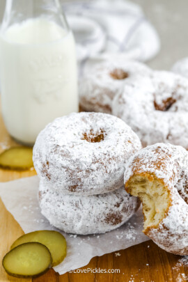 Dill pickle donuts stacked with a bite out of one