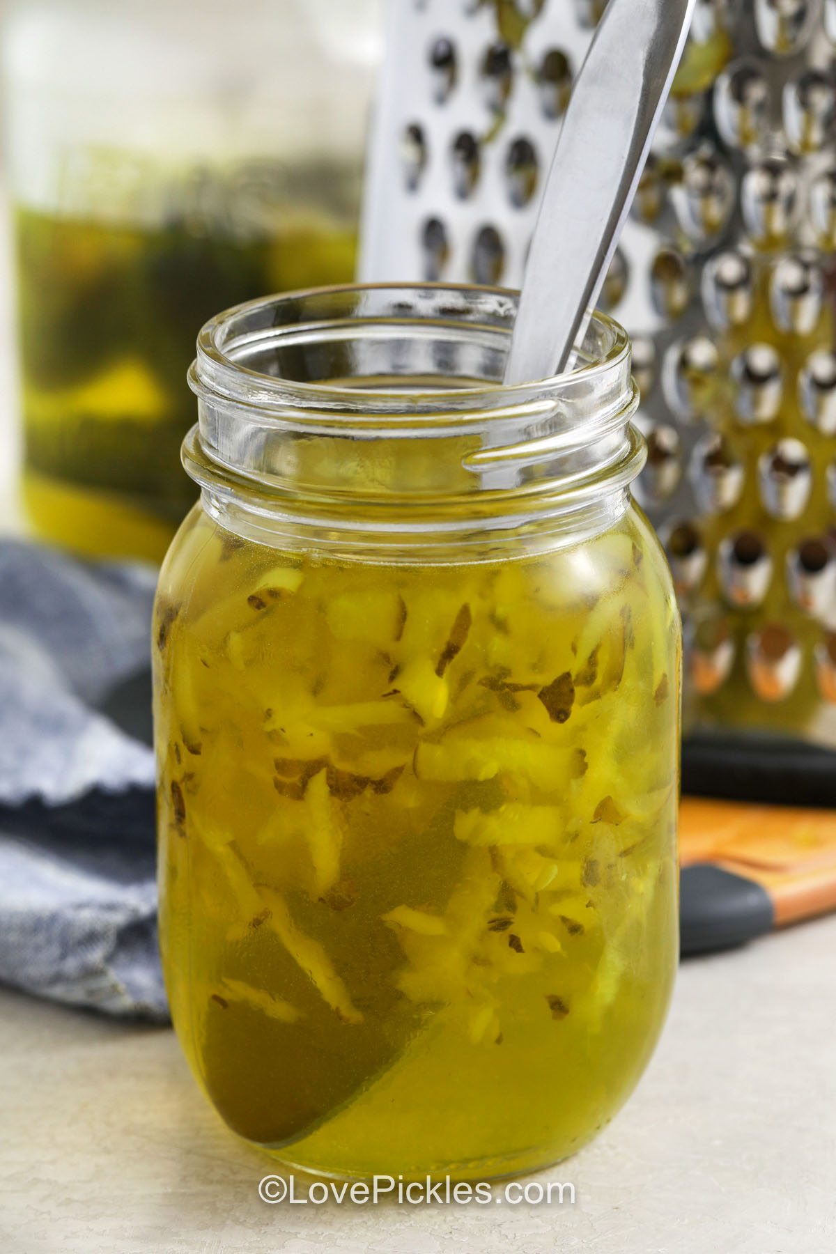 Ingredients to make pickle popsicles combined in a jar