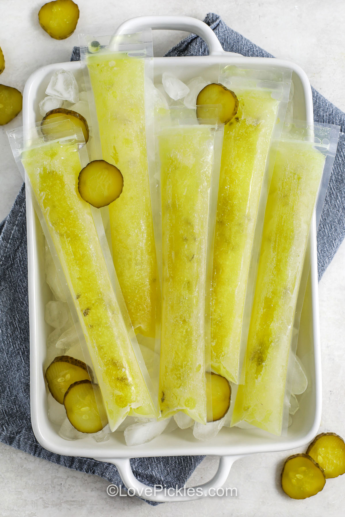 Frozen pickle popsicles on a tray of ice