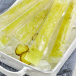 Pickle popsicles on ice with sliced pickles