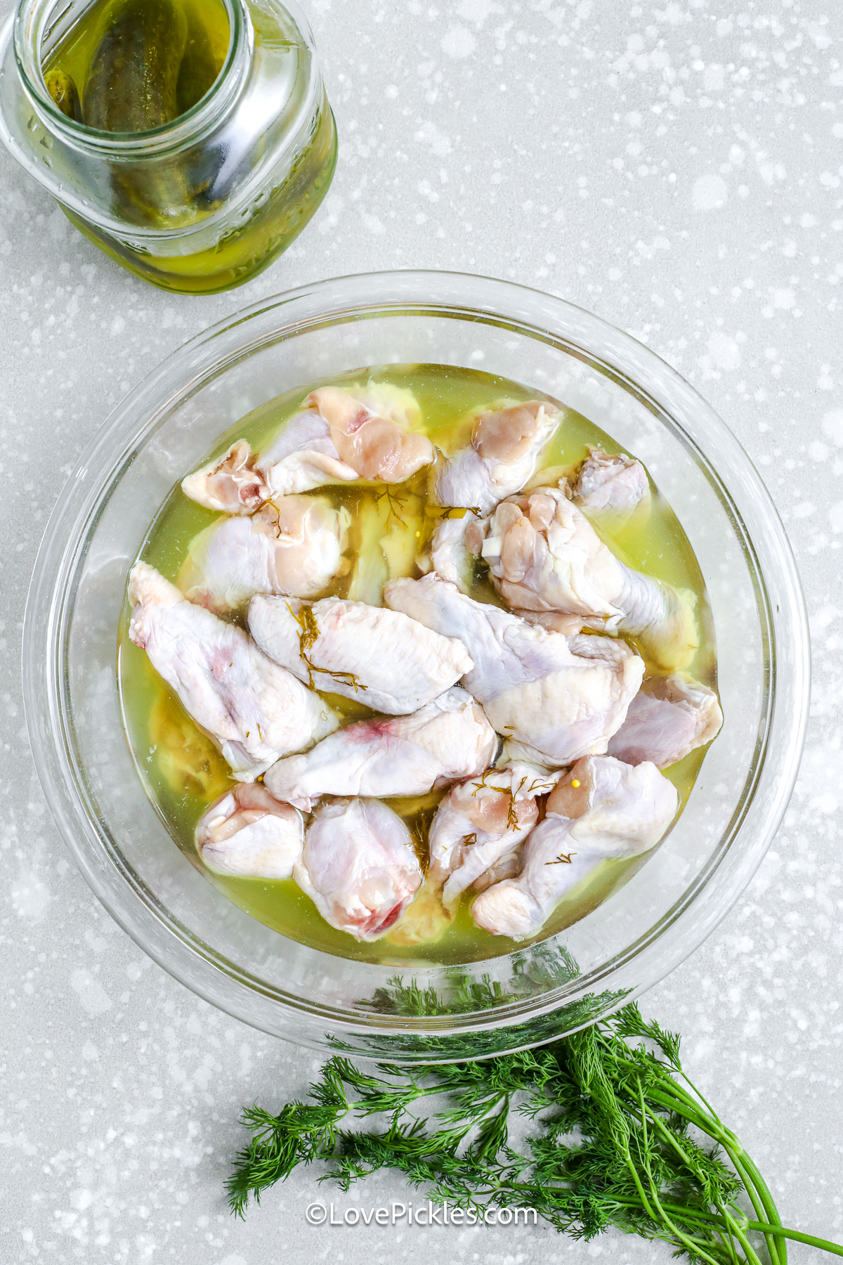 uncooked chicken wings soaking in brine